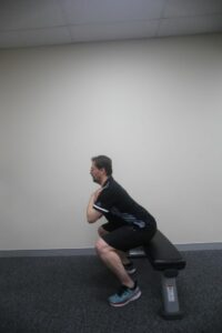 How to do a chair squat / box squat - step 3 side view